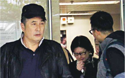 午马的遗孀（中）在富山殓房办理手续，见她离开时手拿纸巾以及双眼红肿